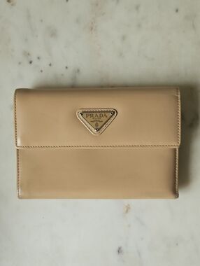 PRADA: Classic Beige Trifold Spazalatto Leather Wallet